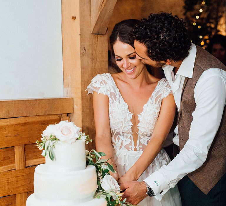 Cutting the Wedding Cake | Bride in Antonia Berta Muse Wedding Dress | Groom in Navy Suit | Rustic Greenery Wedding at Cripps Barn Cotswolds | Wedding_M Photography