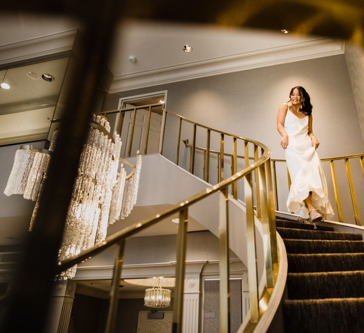 Bride in Silk BHLDN Dress with Spaghetti Straps and V-Back | Bridal Ponytail | Las Vegas Wedding with Gold Sequin Bridesmaids Dresses and Silk Flowers | Chris Barber Photography