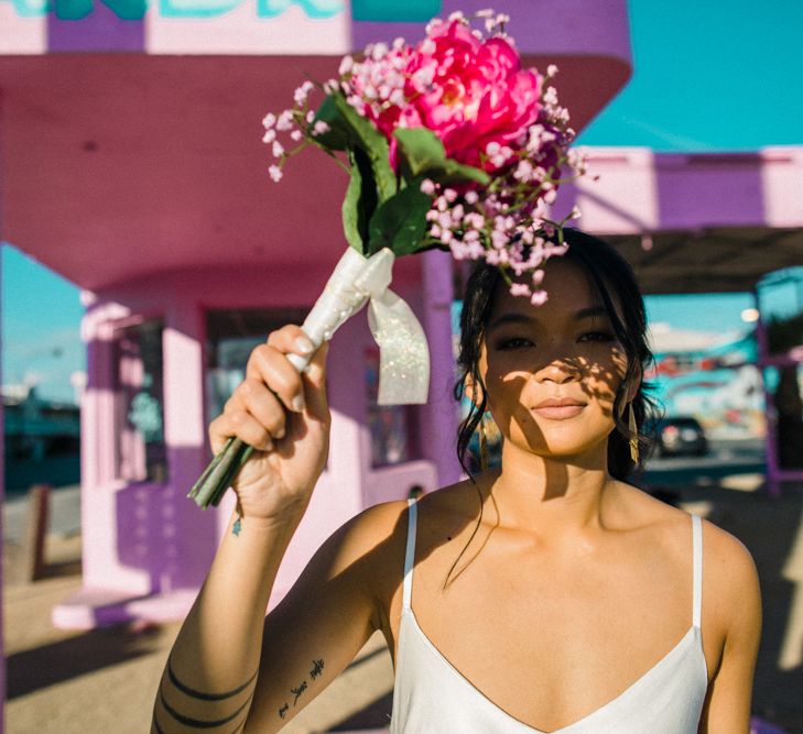 Bride in Silk BHLDN Dress with Spaghetti Straps and V-Back | Bridal Ponytail | Fuschia Sweet Pea Spray Silk Flowers Bouquet | Las Vegas Wedding with Gold Sequin Bridesmaids Dresses and Silk Flowers | Chris Barber Photography