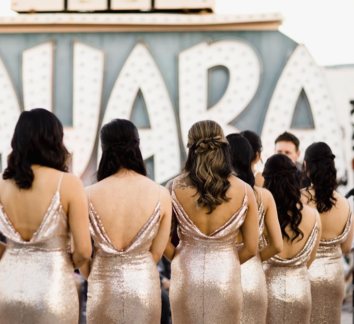 Bridesmaids in Gold Sequin Maxi Dresses with Cowl Back | Wedding Ceremony at The Neon Museum | Las Vegas Wedding with Gold Sequin Bridesmaids Dresses and Silk Flowers | Chris Barber Photography