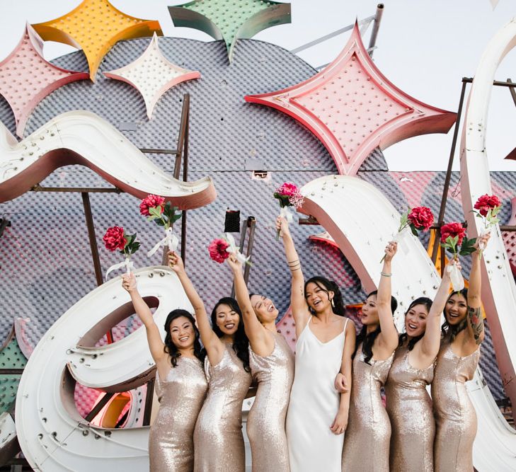 Bride in Silk BHLDN Dress with Spaghetti Straps and V-Back | Bridesmaids in Gold Sequin Maxi Dresses with Cowl Back | Fuschia Sweet Pea Spray Silk Flower Bouquets | Las Vegas Wedding with Gold Sequin Bridesmaids Dresses and Silk Flowers | Chris Barber Photography