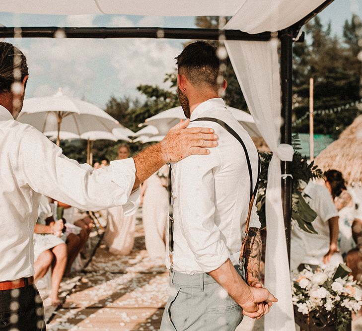 Groom at the Altar in Peach Bow Tie &amp; Braces | Tropical Destination on the Beach at Nice Sea Resort, Koh Phangan Thailand Planned by Phangan Weddings | Carla Blain Photography