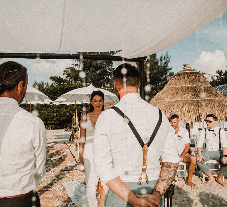 Wedding Ceremony | Bridal Entrance in Grace Loves Lace Gia Gown | Groom in Turned Up Trousers, Bow Tie &amp; Braces from Topman | Tropical Destination on the Beach at Nice Sea Resort, Koh Phangan Thailand Planned by Phangan Weddings | Carla Blain Photography