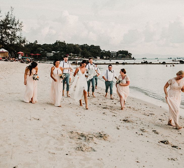 Wedding Party | Bridesmaids in Peach Gowns | Bride in Grace Loves Lace Gia Wedding Dress | Groomsmen in Turned Up Trousers, Bow Ties &amp; Braces from Topman | Tropical Destination on the Beach at Nice Sea Resort, Koh Phangan Thailand Planned by Phangan Weddings | Carla Blain Photography