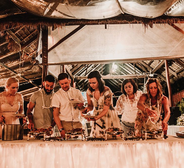 Outdoor Reception | Fairy Light Canopy | Bride in Grace Loves Lace Gia Wedding Dress | Groomsmen in Turned Up Trousers, Bow Ties &amp; Braces from Topman | Tropical Destination on the Beach at Nice Sea Resort, Koh Phangan Thailand Planned by Phangan Weddings | Carla Blain Photography