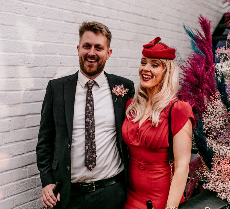 Wedding Guest in Red Dress and Hat with Birdcage Veil