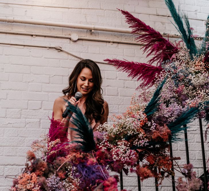 Bridesmaid Giving a Wedding Speech on the Steps Covered in Flowers