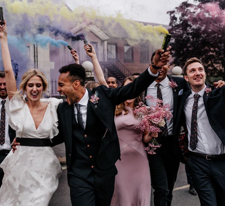 Bride in Ruffle Wedding Dress and Groom in Three Piece Navy Suit