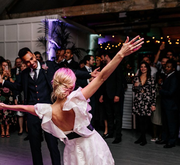 Bride and Groom First Dance with Bride in Ruffle Sleeve Wedding Dress