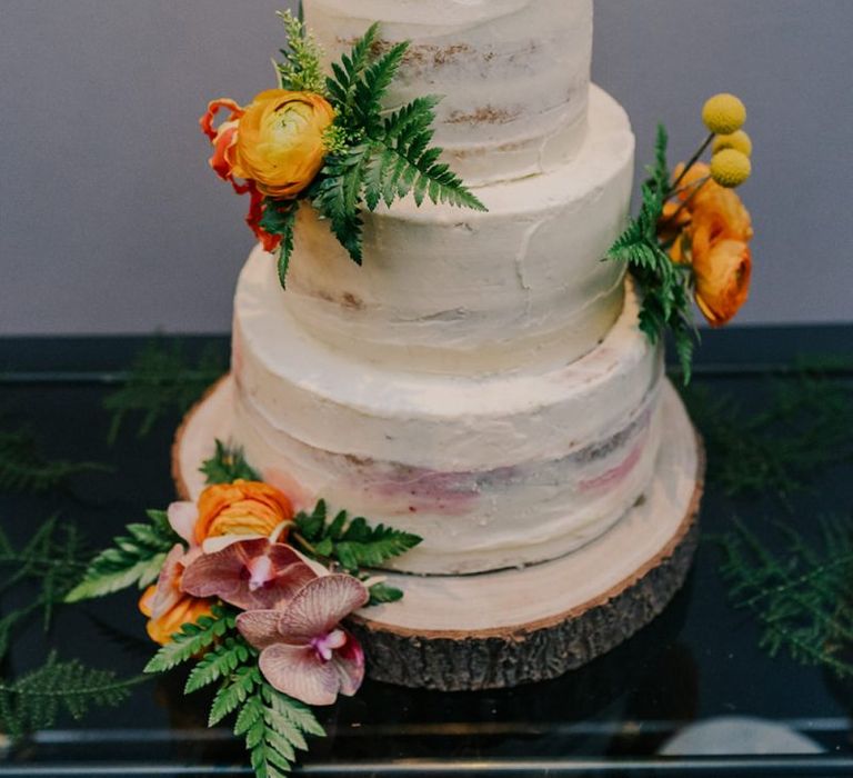 Semi-Naked Wedding Cake With Flower Decoration on Tree Slice