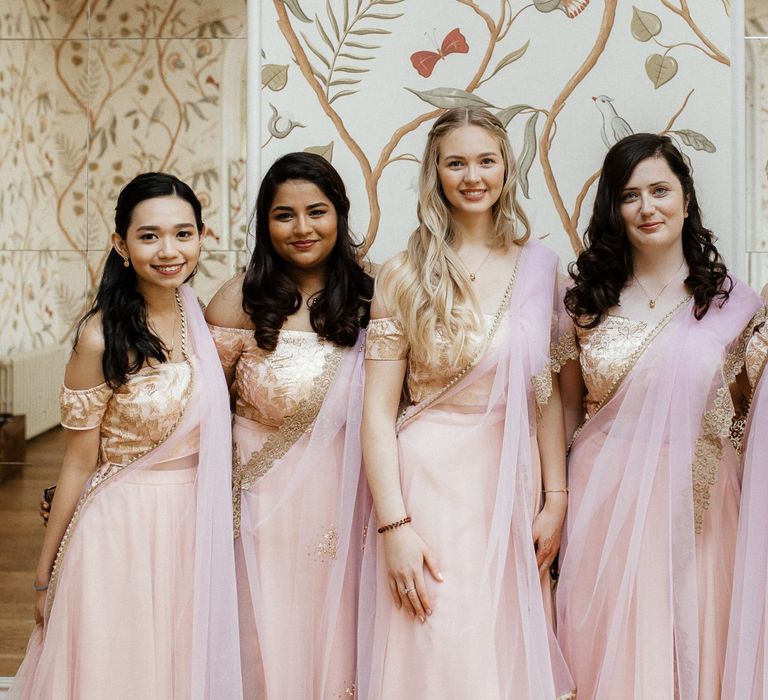 Pink sari for bridal party and navy Indian wedding dress for bride