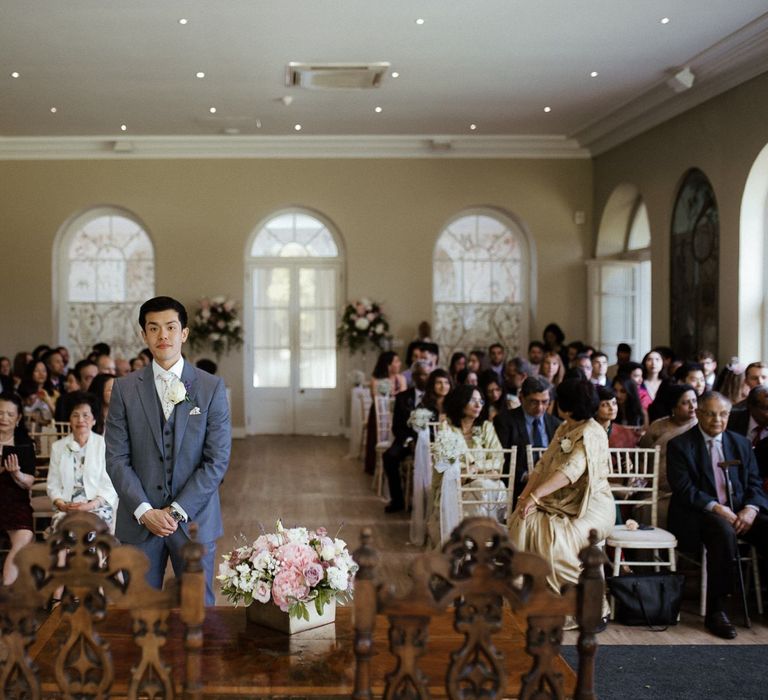 Groom waits for bride at ceremony