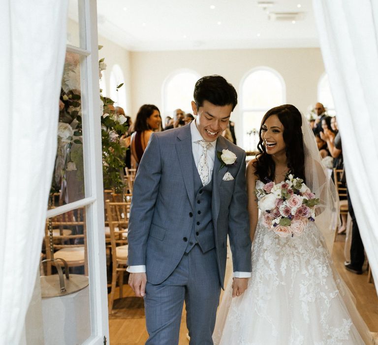 Bride and groom emerge from ceremony as husband and wife