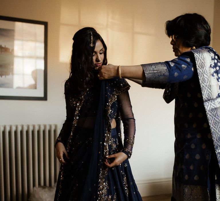 Bride changes into navy Indian wedding dress