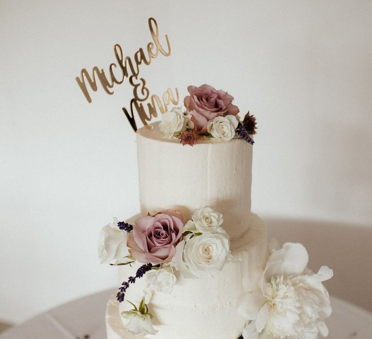 White wedding cake with pink flower decor