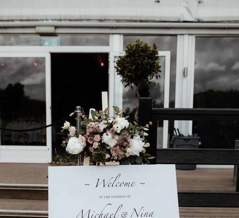 Wedding welcome sign with pink wedding flowers