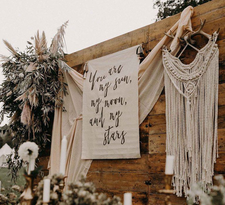 Rustic Tablescape with Drapes, Fabric Flag Backdrop, Dried Flowers &amp; Macrame Hanging | Nude Bohemian Wedding Inspiration by Wonderland Invites &amp; Rock The Day Styling | Kelsie Low Photography