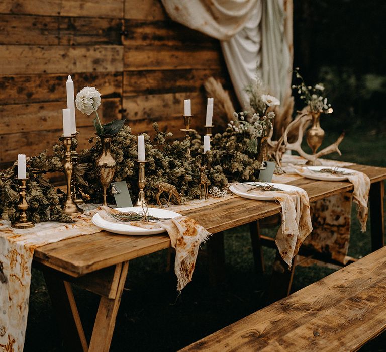 Wooden Backdrop with Drapes, Dried Flowers &amp; Macrame Decor | Wooden Table with Candle Sticks &amp; Greenery Garland | Nude Bohemian Wedding Inspiration by Wonderland Invites &amp; Rock The Day Styling | Kelsie Low Photography