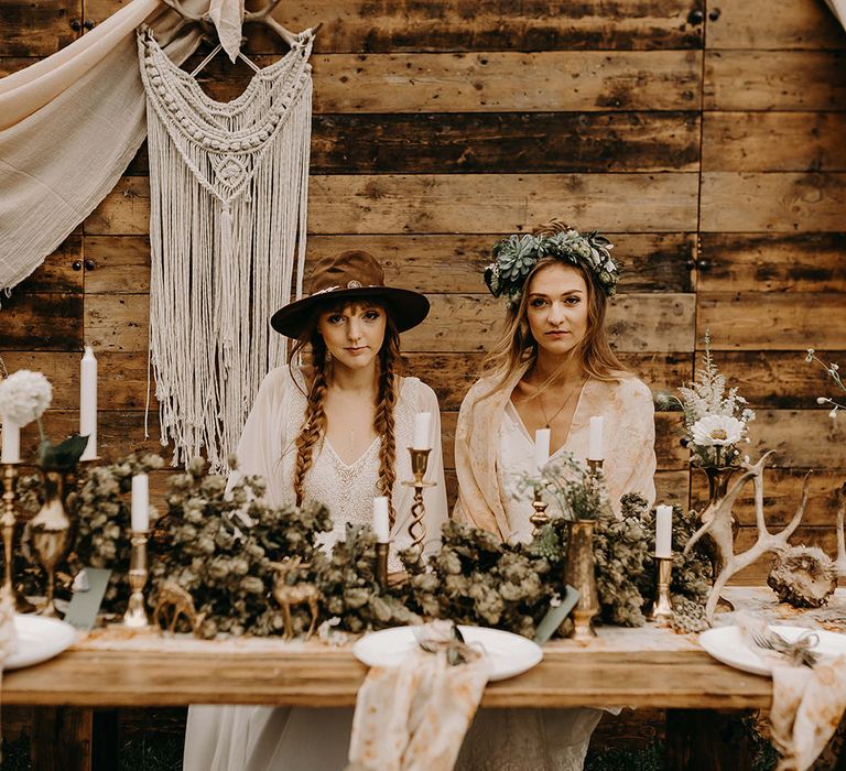 Boho Brides in Lace Dresses, Hats &amp; Succulent Flower Crowns | Drapes, Dried Flowers &amp; Macrame Decor | Wooden Table with Candle Sticks &amp; Greenery Garland | Nude Bohemian Wedding Inspiration by Wonderland Invites &amp; Rock The Day Styling | Kelsie Low Photography