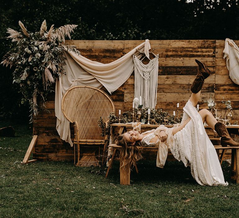 Boho Bride in Lace Wedding Dress | Wooden Backdrop with Drapes, Dried Flowers &amp; Macrame Decor | Wooden Table with Candle Sticks &amp; Greenery Garland | Nude Bohemian Wedding Inspiration by Wonderland Invites &amp; Rock The Day Styling | Kelsie Low Photography