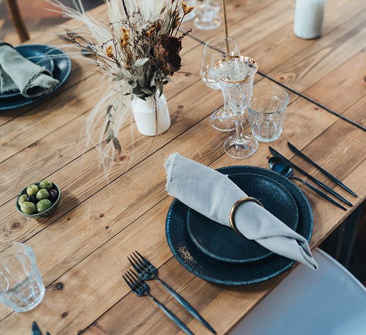 Dried foliage table flowers styled with dark and earthy tones for autumn reception