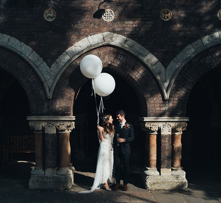 Bride and groom tie the knot at relaxed autumn wedding with dried floral decor and balloon installation