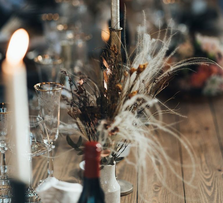 Dark and earthy tones mixed with metallic touches and dried foliage at autumn reception with balloon installation