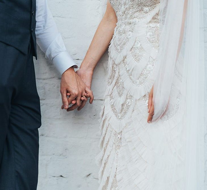 Close up of brides beautifully embellished dress with intricate beading detail