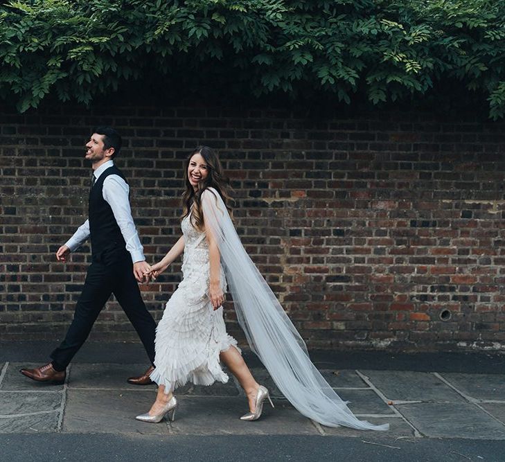 Bride and groom at relaxed autumn wedding with earthy styling, dried decor and balloon installation