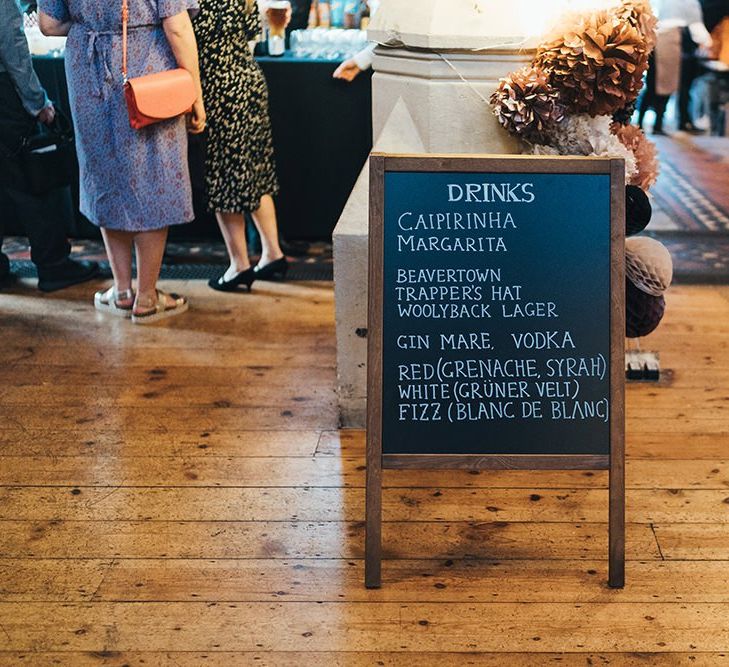 Chalkboard wedding sign with dried floral decor at autumn reception with balloon installation