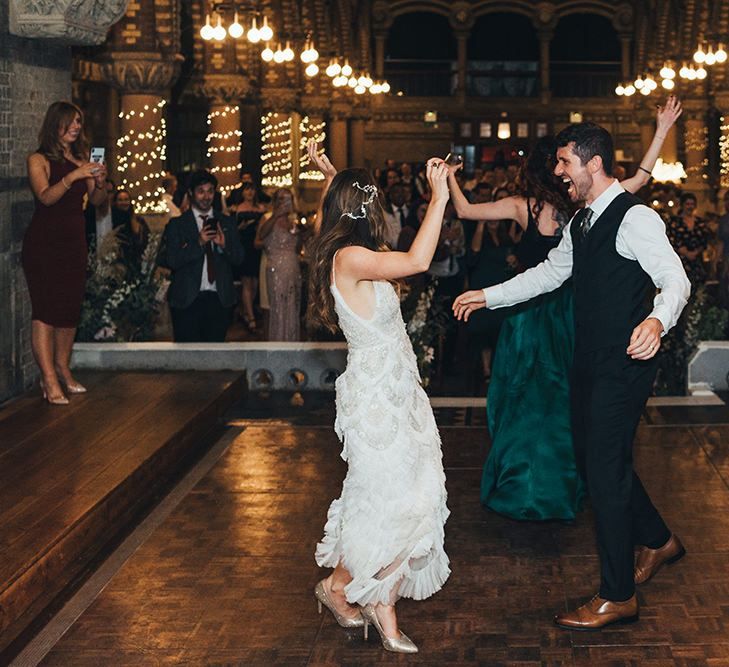 Bride and groom enjoying their relaxed wedding reception with balloon installation