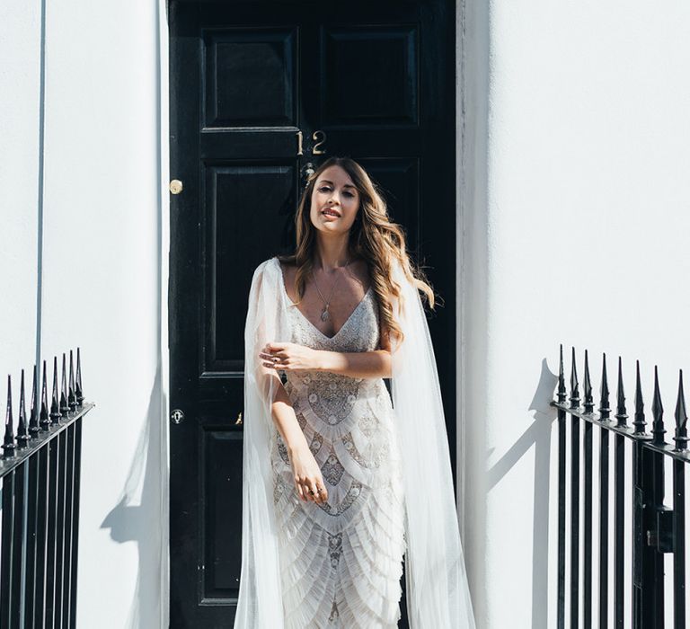 Bride wearing a custom made embellished Emma Beaumont dress with watteau train