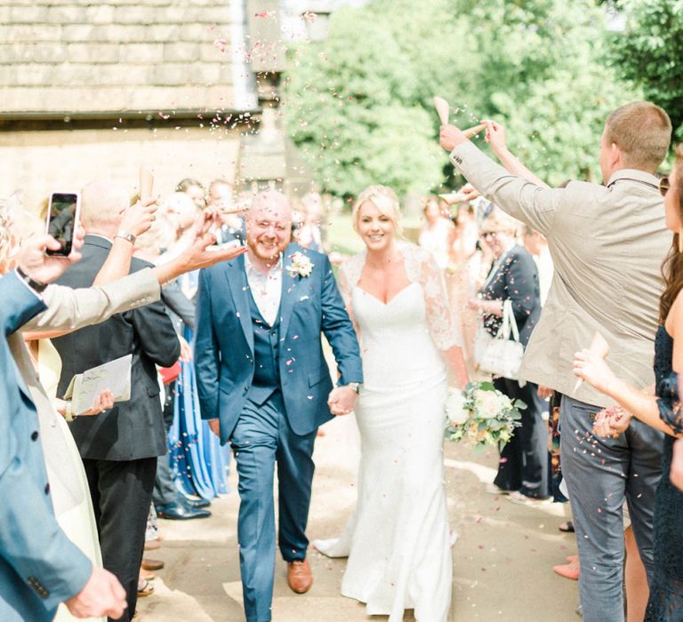 Confetti Moment with Bride in Suzanne Neville Wedding Dress and Lace Bolero and Groom in Navy Hugo Boss Suit