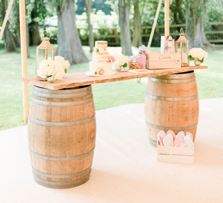 Wooden Barrel Cake Table with Semi Naked Wedding Cake, Lanterns and Flowers to Decorate