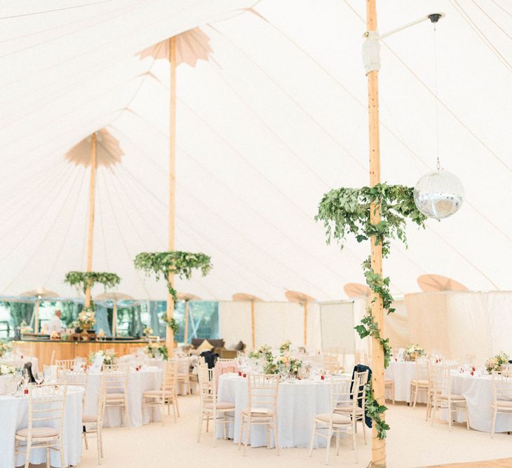 PapaKata Sperry Tent Reception with Foliage Wrapped around Poles and Greenery Chandeliers