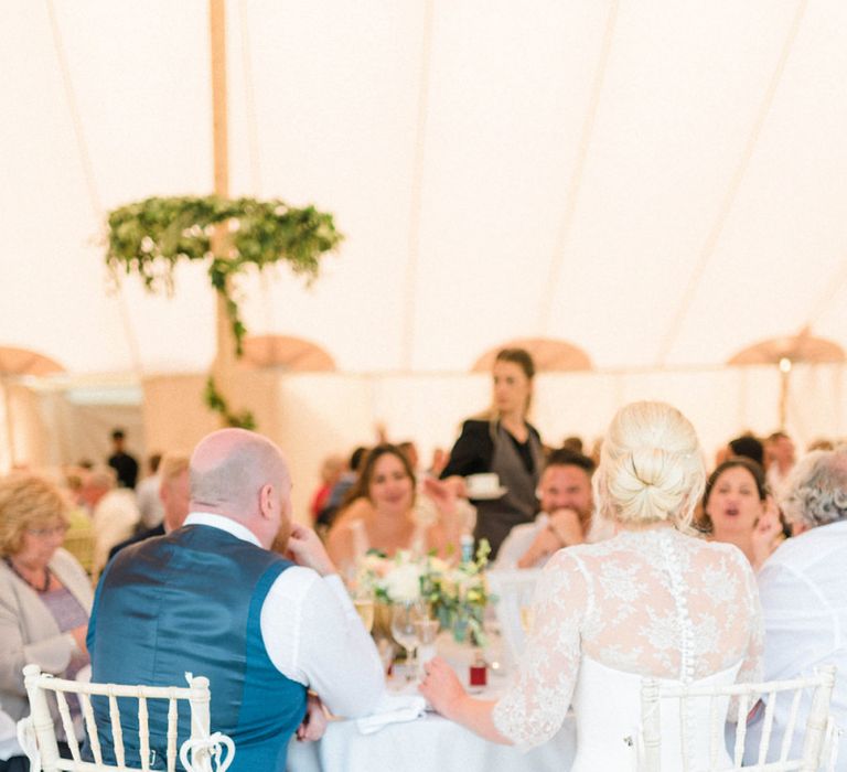 Bride and Groom Sitting at a Sweetheart Table During the Wedding Breakfast Reception