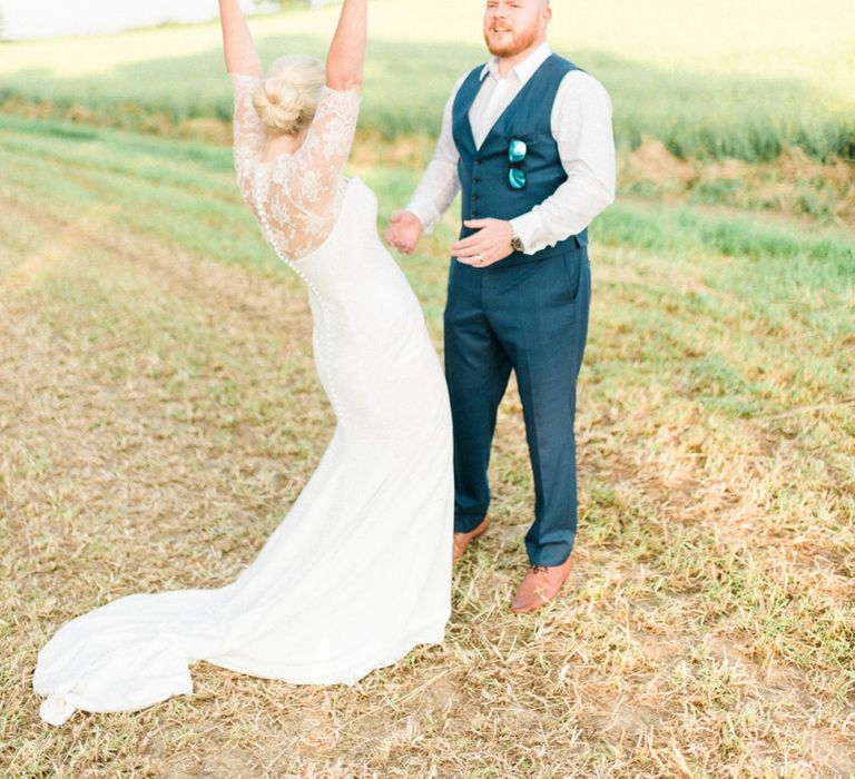 Bride in Suzanne Neville Wedding Dress and Lace Bolero and Groom in Hugo Boss Waistcoat and Trousers Celebrating