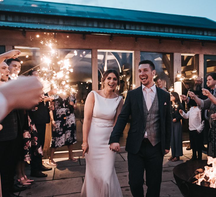 Sparklers on exit | Blush Pink and Copper | RMW The List Members Hazel Gap Barn, Nottinghamshire | Mikaella Bridal Gown | Pear and Bear Photography