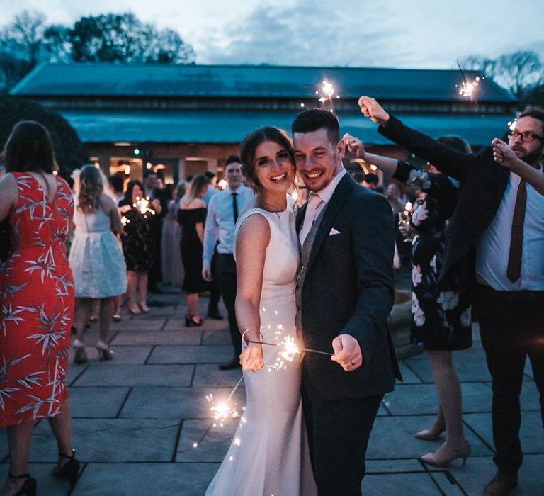 Sparklers on exit | Blush Pink and Copper | RMW The List Members Hazel Gap Barn, Nottinghamshire | Mikaella Bridal Gown | Pear and Bear Photography