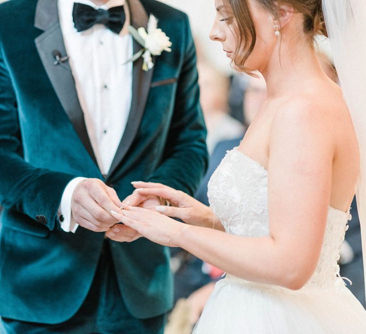 Bride in detachable skirt wedding dress exchanging rings with groom