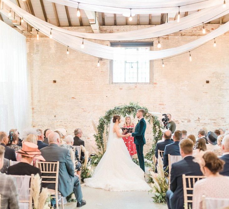 Wedding ceremony at Calke Abbey with drapes and moon gate