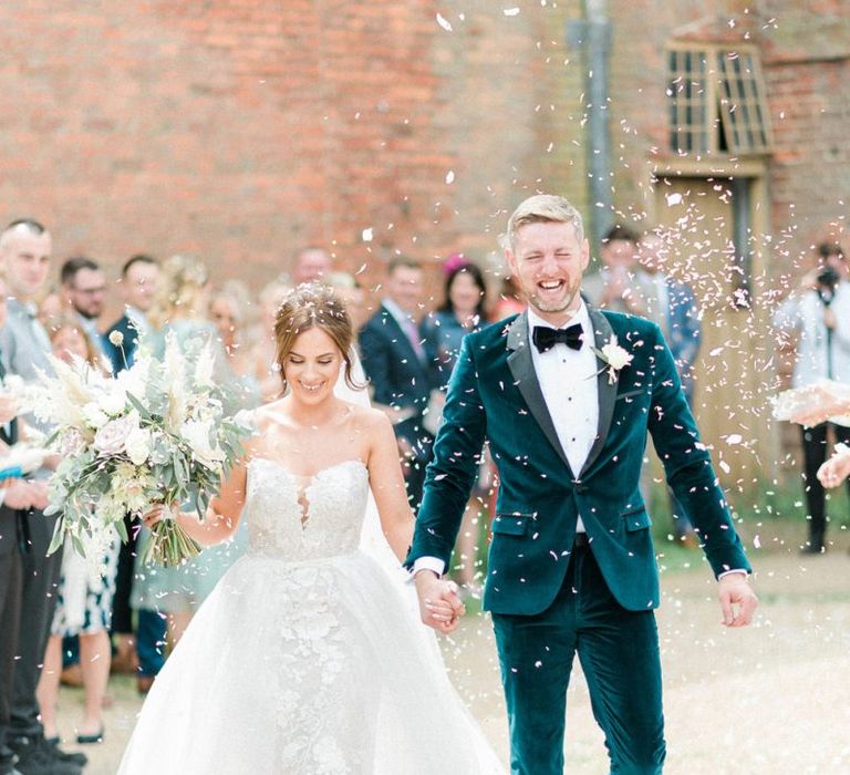 Confetti exit for bride in detachable skirt wedding dress and groom