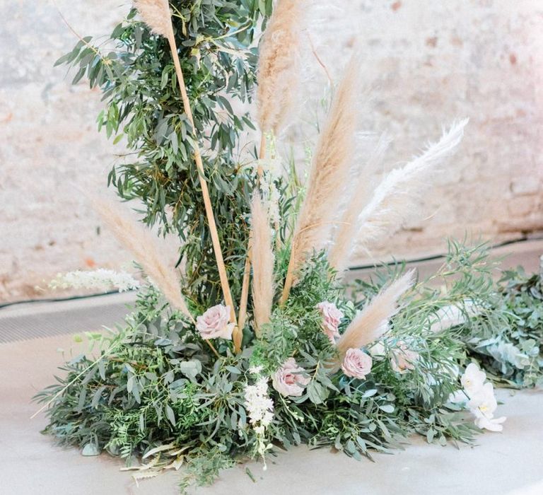 Foliage moon gate at ceremony with pampas grass