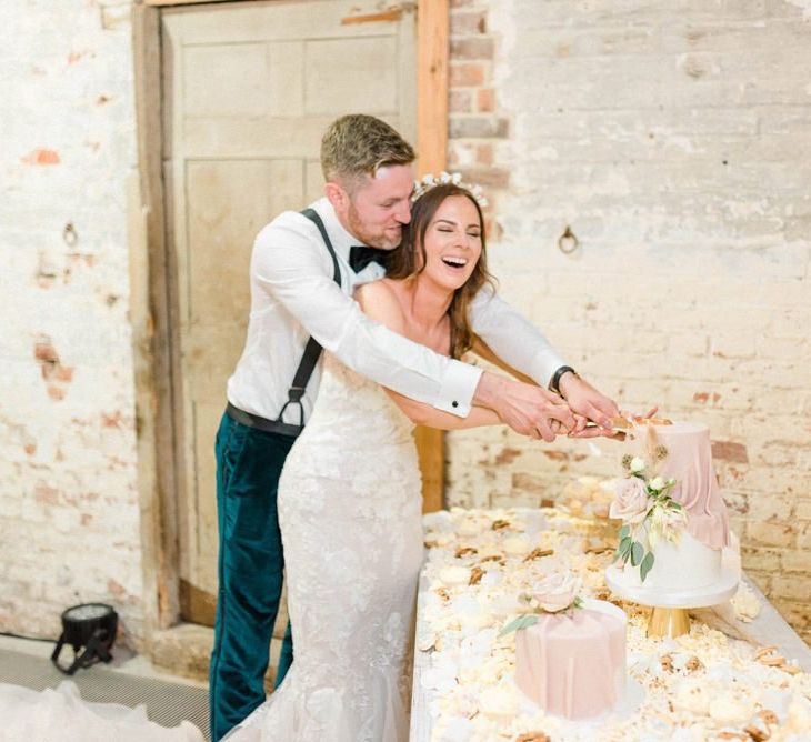 Bride and groom cut the wedding cake