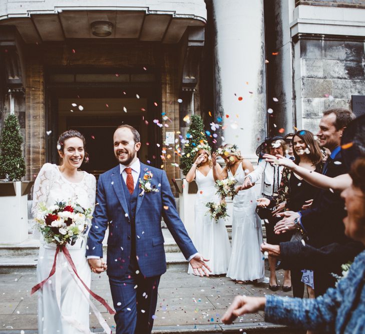 Confetti Exit | Bride in Laure de Sagazan Gown | Groom in Reiss Suit | Autumn City Wedding at Clissold House,  West Reservoir Centre | A Thing Like That Photography