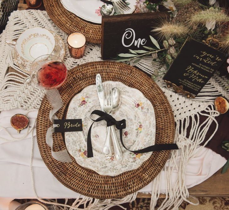 Place Setting with Wicker Place Mat, Floral Plate and Cutlery Tied with Ribbon