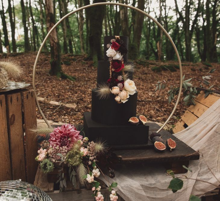 Black Wedding Cake with Flower Decor on Hoop Cake Stand