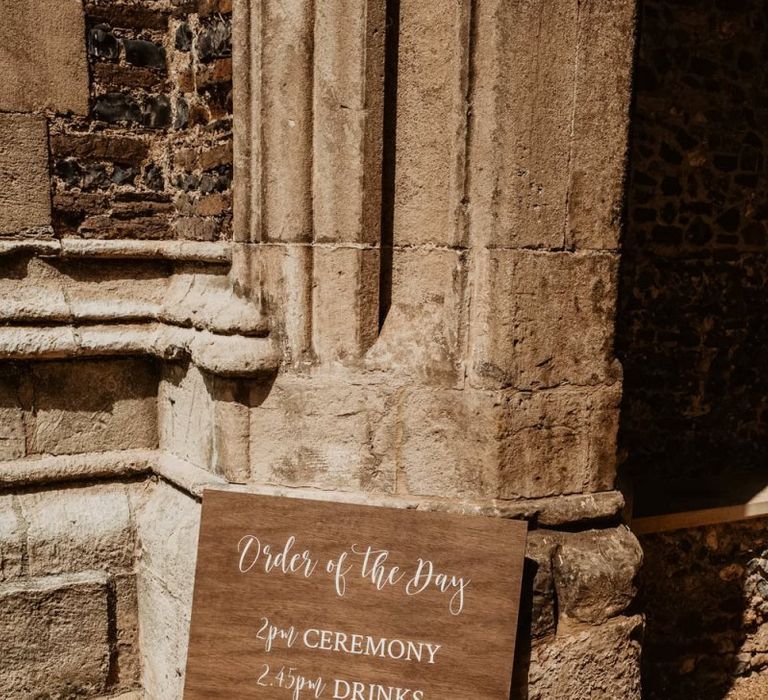 rustic wedding timeline signage with white calligraphy