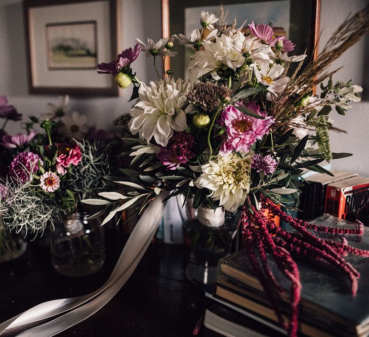 Pink, Purple and White Wildflower Bouquets Tied with Hessian and Lace | Rue de Seine Wedding Dress with Pronovias Overskirt, Personalised Place Setting Illustrations and Sweetheart Table | Samuel Docker Photography