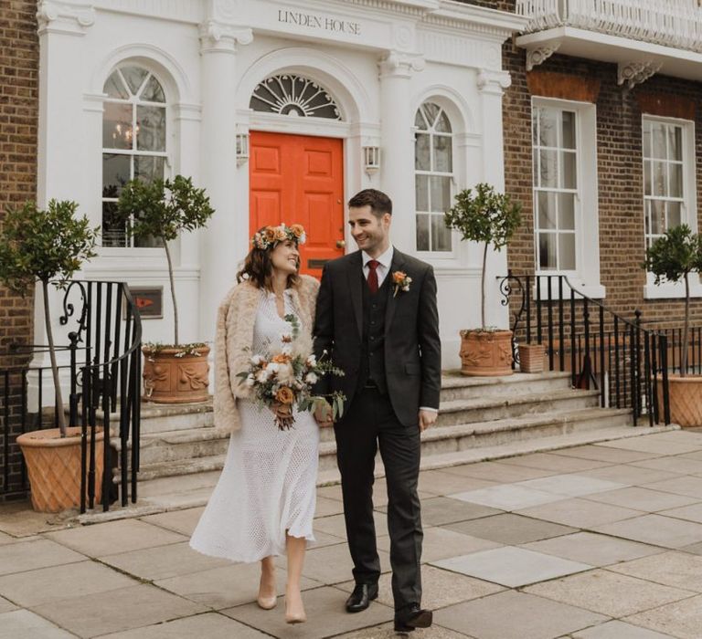 Bride wearing 70s vintage dress and faux fur jacket at Linden House wedding ceremony